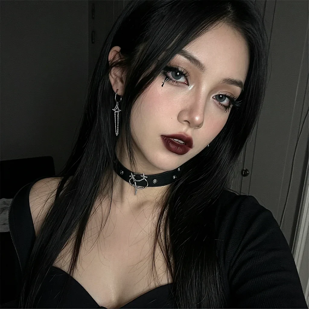 Fictional AI character with a studded choker and dark lipstick, close portrait in a pale room